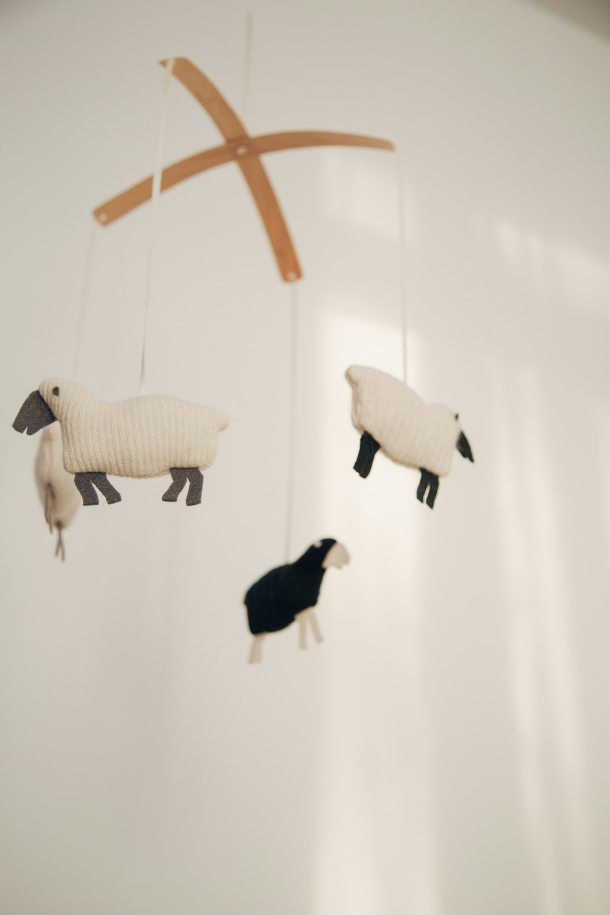 A soft nursery mobile hanging in a baby's room